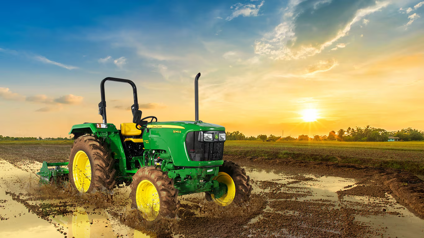 John Deere tractor in agricultural field representing professional tractor repair and maintenance services