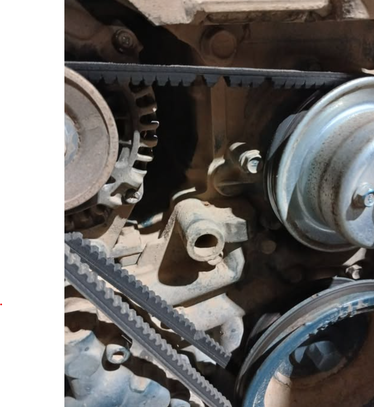 Detailed view of tractor engine components showing gears, belts, and mechanical parts for repair services